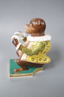 A Derby rare figure from a bear band, c.1820, wearing a green, gold and yellow jacket playing the cymbals, seated on the base, crossed swords mark in blue 10cm